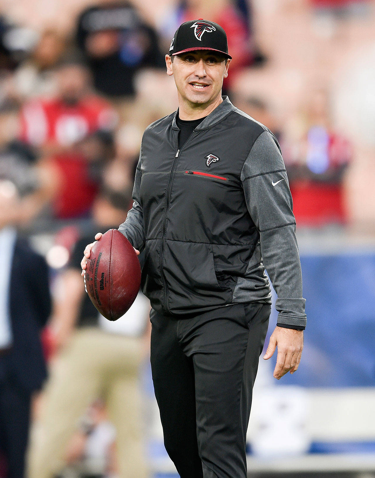 Atlanta offensive coordinator Steve Sarkisian looks on as the Falcons warm up for their NFC wild-card playoff game against the Los Angeles Rams on Jan. 6 in Los Angeles. (AP Photo/Kelvin Kuo)