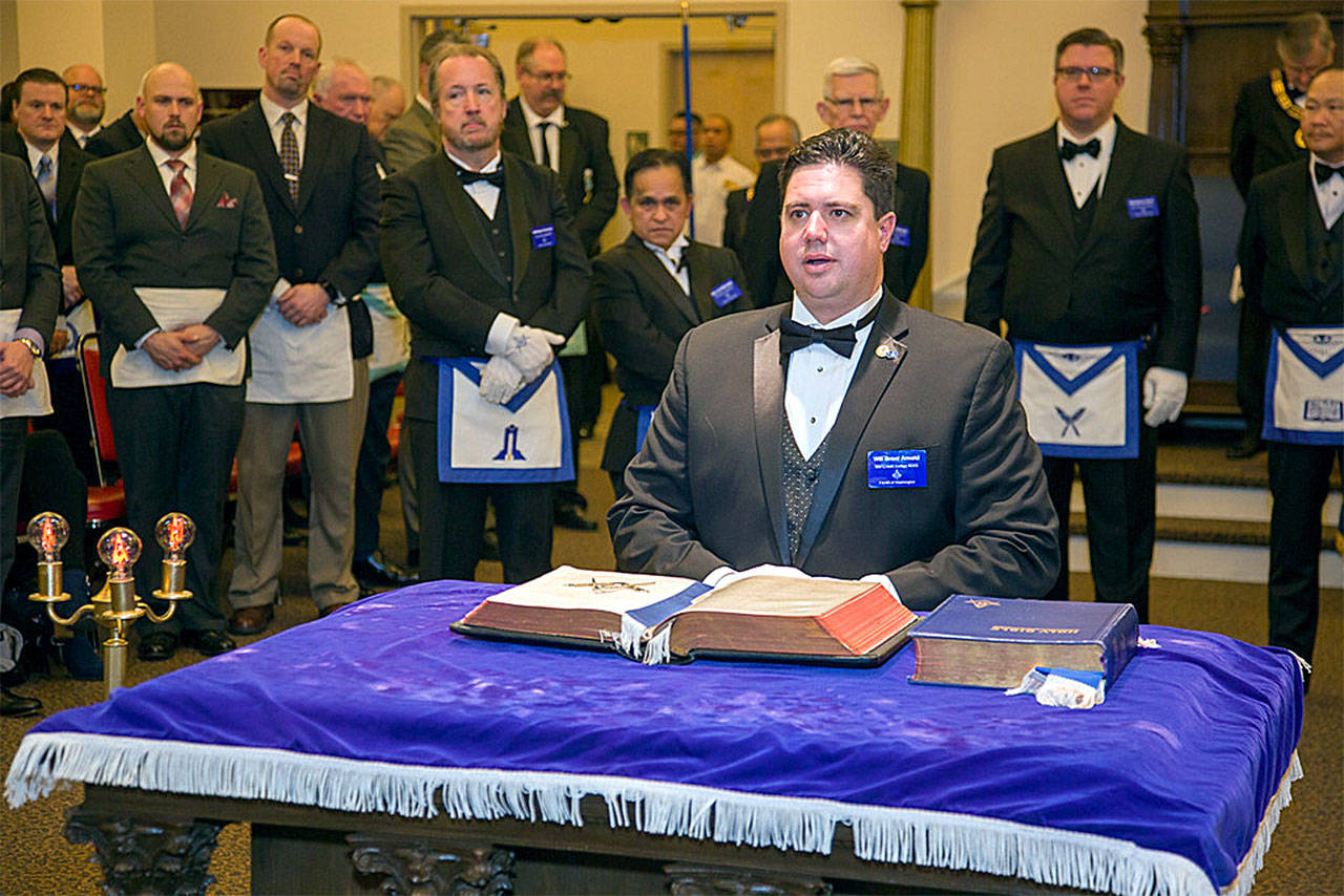 Brent Arnold kneels as he is installed as the new Master of the newly formed Masonic Mill Creek Lodge No. 243 during a Dec. 30 merger celebration. (Photo by MarTeam Photography)