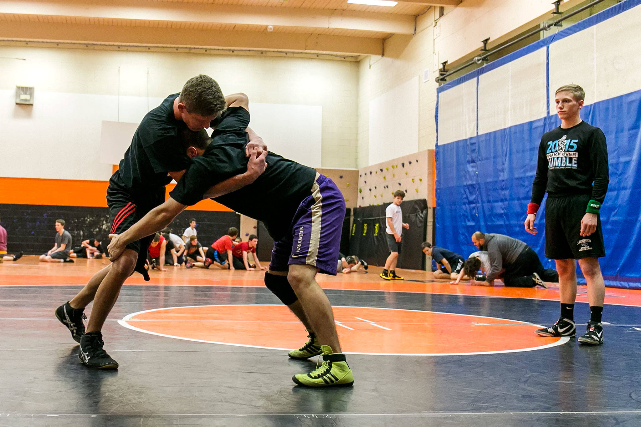 Monroe’s Nathan Bennett (left) wrestles Wilmer Chacon with Taylor Ivy refereeing during practice on Jan. 17, 2018, at Sky Valley Education Center in Monroe. (Kevin Clark / The Herald)