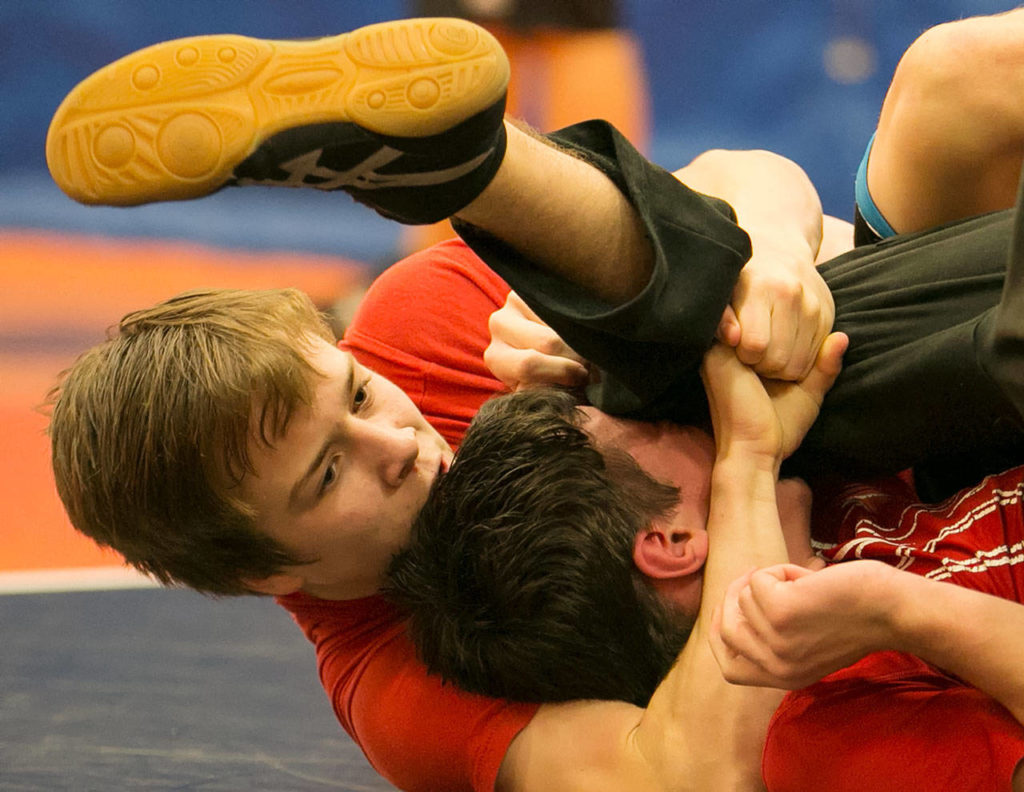 Monroe’s Chad Pease locks Josh Maggard during practice on Jan. 17, 2018, at Sky Valley Education Center in Monroe. (Kevin Clark / The Herald)
