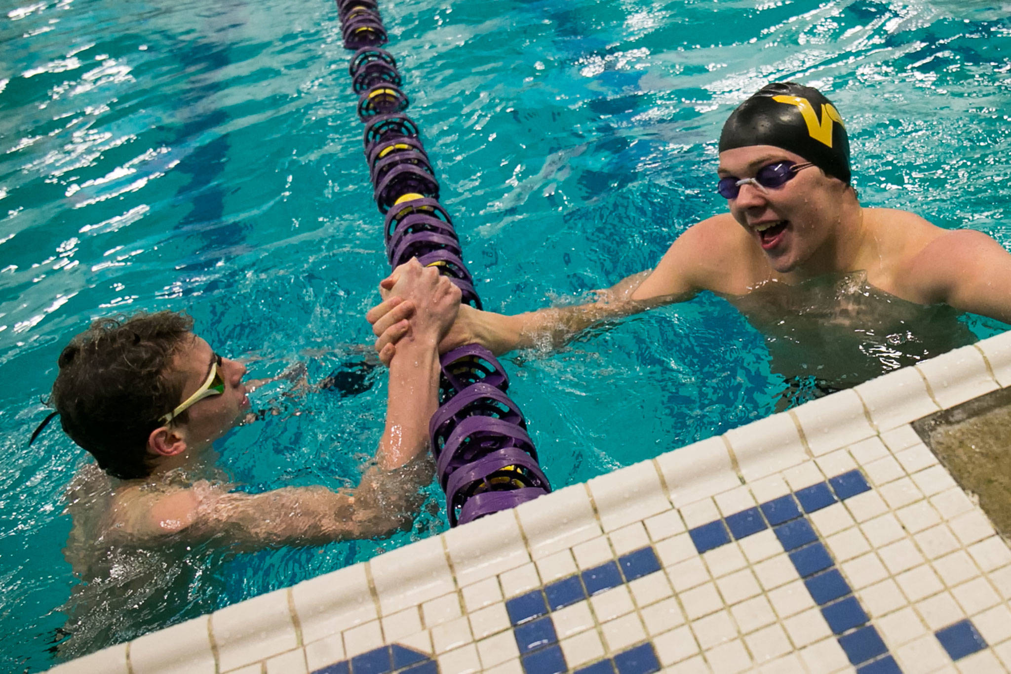 Glacier Peak’s Matthew King (left) congratulates Lake Stevens’ Carter Walles Thursday after Walles won the 100-yard backstroke event during a matchup of three top Wesco boys swimming and diving squads at Lake Stevens High School. King finished second. The Vikings beat the Grizzlies 99-84 and Snohomish 123-63. (Kevin Clark / The Herald)