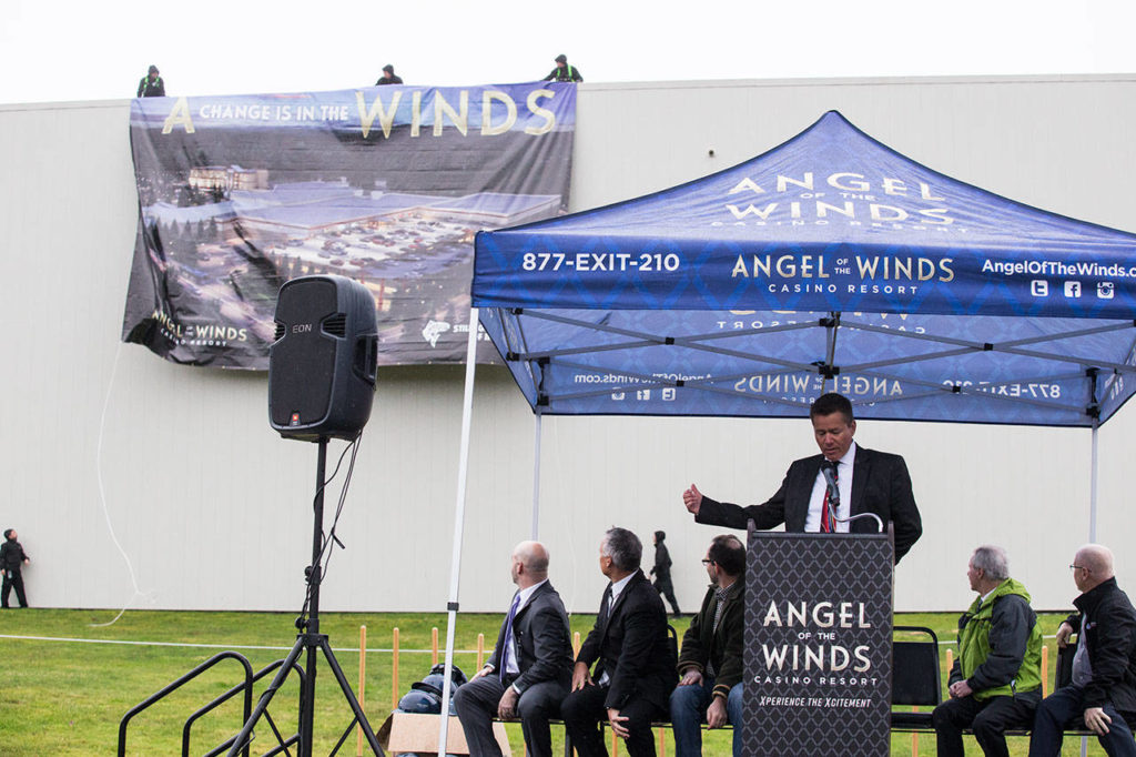 A banner unfurls behind general manager Travis O’Neil as he speaks during a groundbreaking ceremony for a more than $60 million expansion at the Angel of the Winds Casino Resort on Tuesday in Arlington. (Andy Bronson / The Herald)
