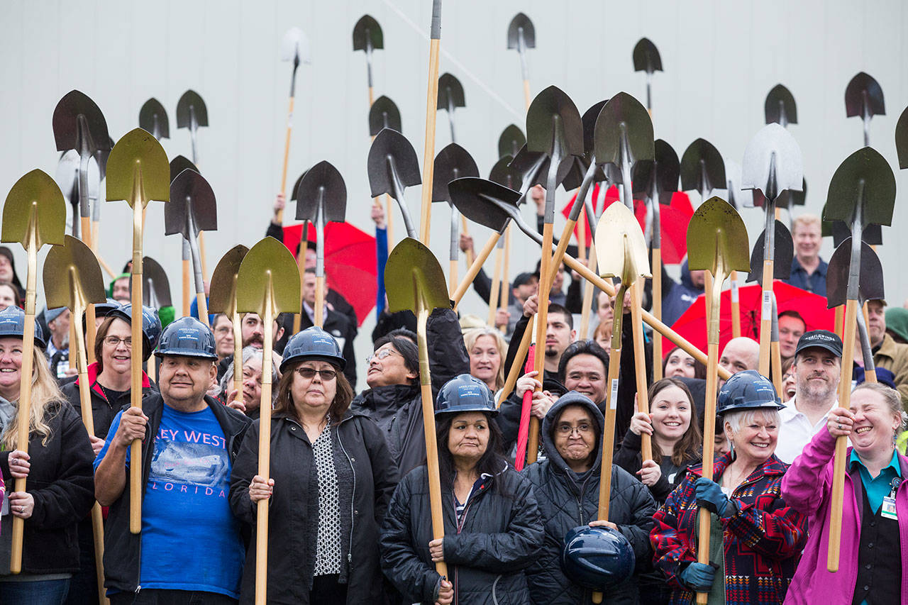 Stillaguamish tribal members and guests hold up shovels during a groundbreaking ceremony for a more than $60 million expansion at the Angel of the Winds Casino Resort on Tuesday in Arlington. (Andy Bronson / The Herald)