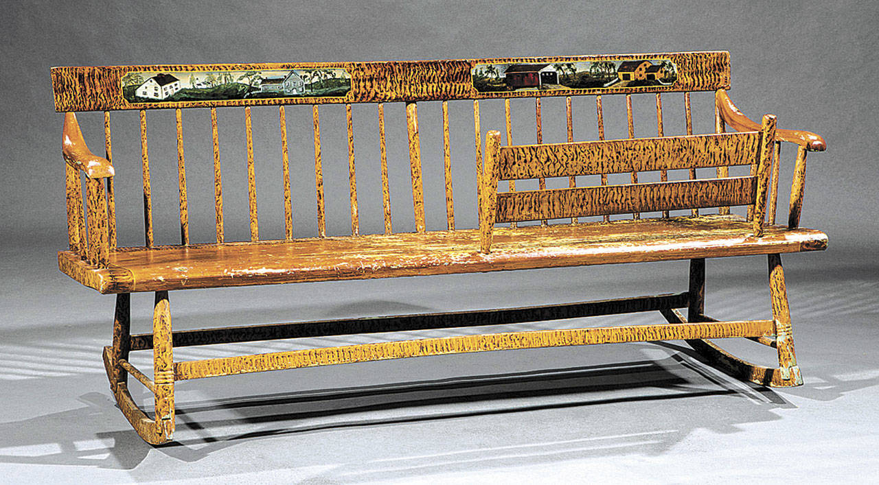 This rocking-settee-cradle also is called a double-seated Windsor or Cape Cod rocker. It was made in about 1810, and sold for $976. (Cowles Syndicate Inc.)