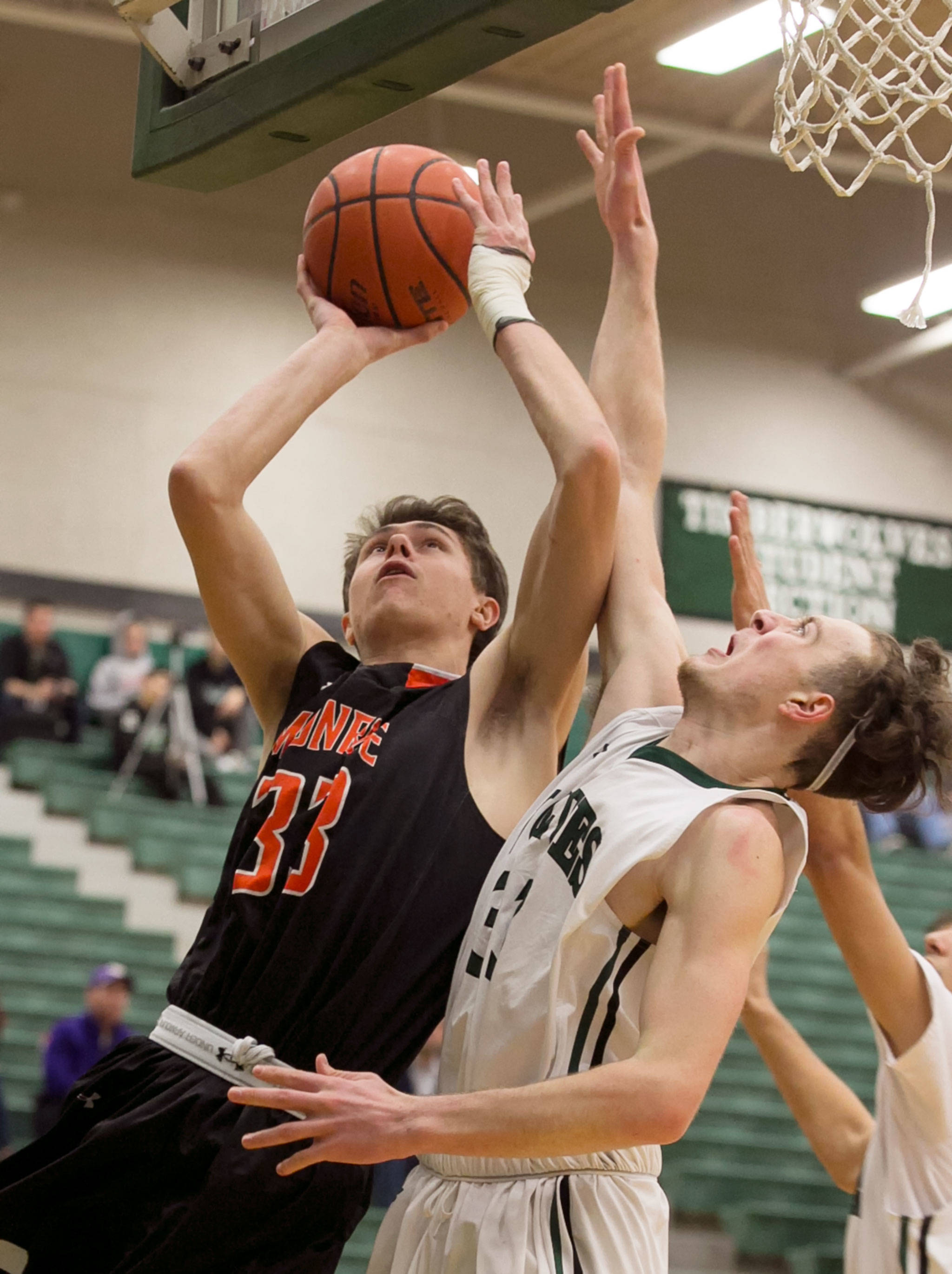 Monroe’s Colby Kyle goes up to the basket as Jackson’s Kyle Bigovich defends during a Wesco 4A matchup Friday in Mill Creek. Kyle scored 24 points to help the Bearcats to a 79-67 win. (Kevin Clark / The Daily Herald)