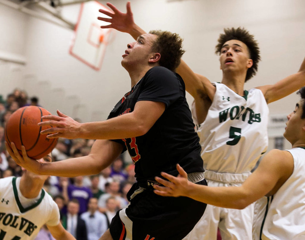 Monroe’s Isaiah Cole attempts a shot with Jackson’s Christian Liddell defending during a Wesco 4A matchup Friday in Mill Creek. Cole and the Bearcats beat the Timberwolves 79-67, despite 35 points from Liddell. (Kevin Clark / The Daily Herald)
