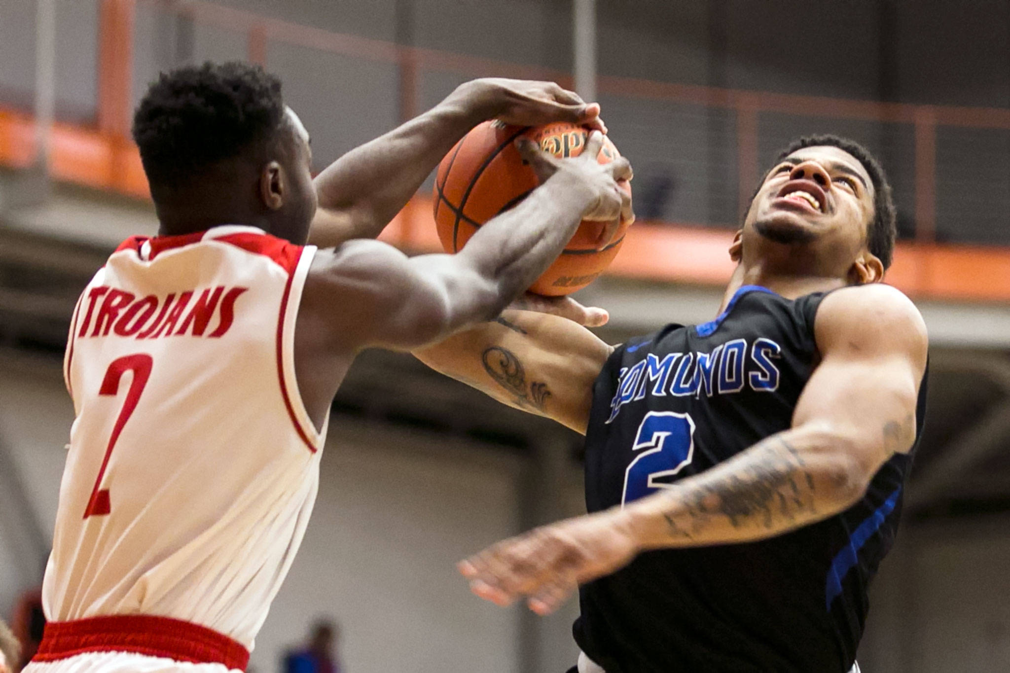 Everett Community College’s Gio Jackson (left) blocks a shot attempt by Edmonds Community College’s Raven Frazier during a game on Jan. 20, 2018, at the Walt Price Student Fitness Center in Everett. The Trojans won 117-100. (Kevin Clark / The Herald)