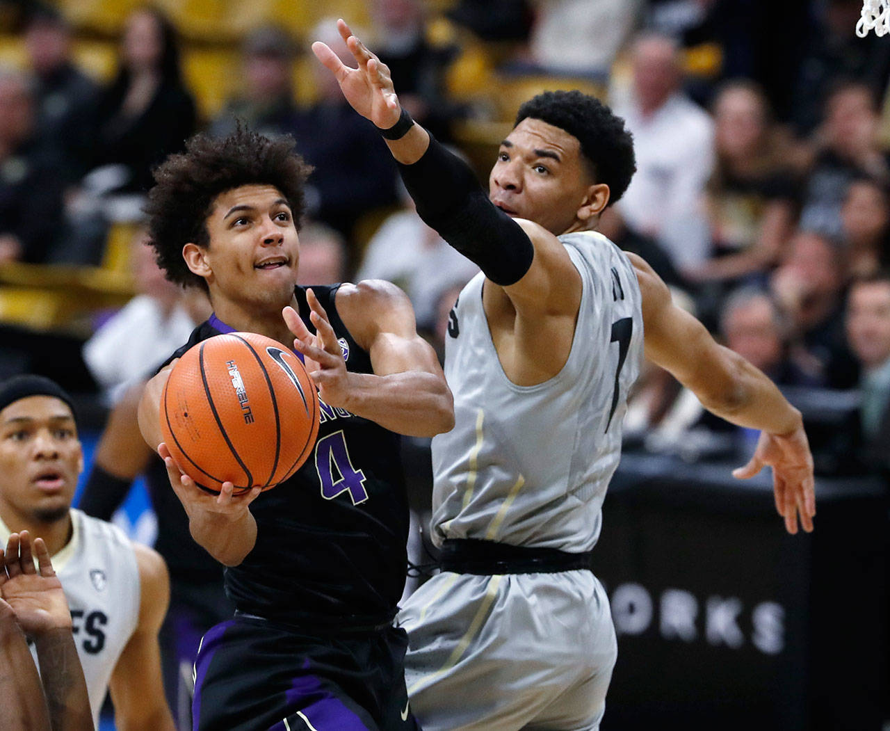 Washington guard Matisse Thybulle (left) drive to the basket past Colorado guard Tyler Bey during the first half of a game Jan. 20, 2018, in Boulder, Colo. (AP Photo/David Zalubowski)