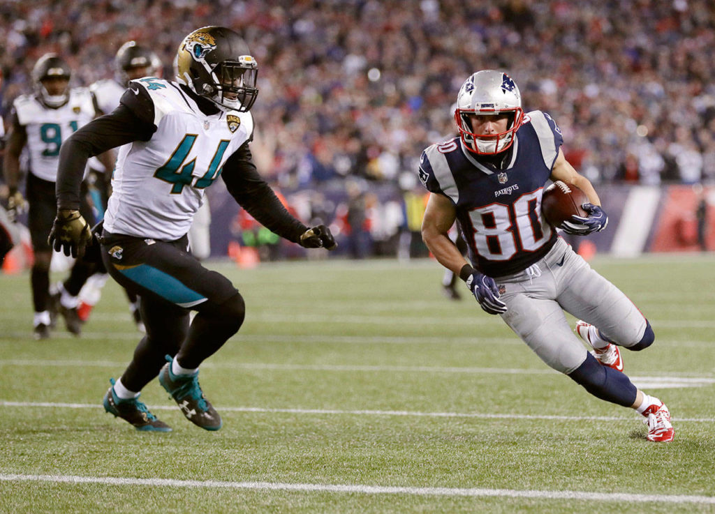 New England Patriots wide receiver Danny Amendola (80) runs to the end zone against Jacksonville Jaguars linebacker Myles Jack (44) for a touchdown after catching a pass during the second half of the AFC championship NFL football game, Sunday, Jan. 21, 2018, in Foxborough, Mass. (AP Photo/David J. Phillip)
