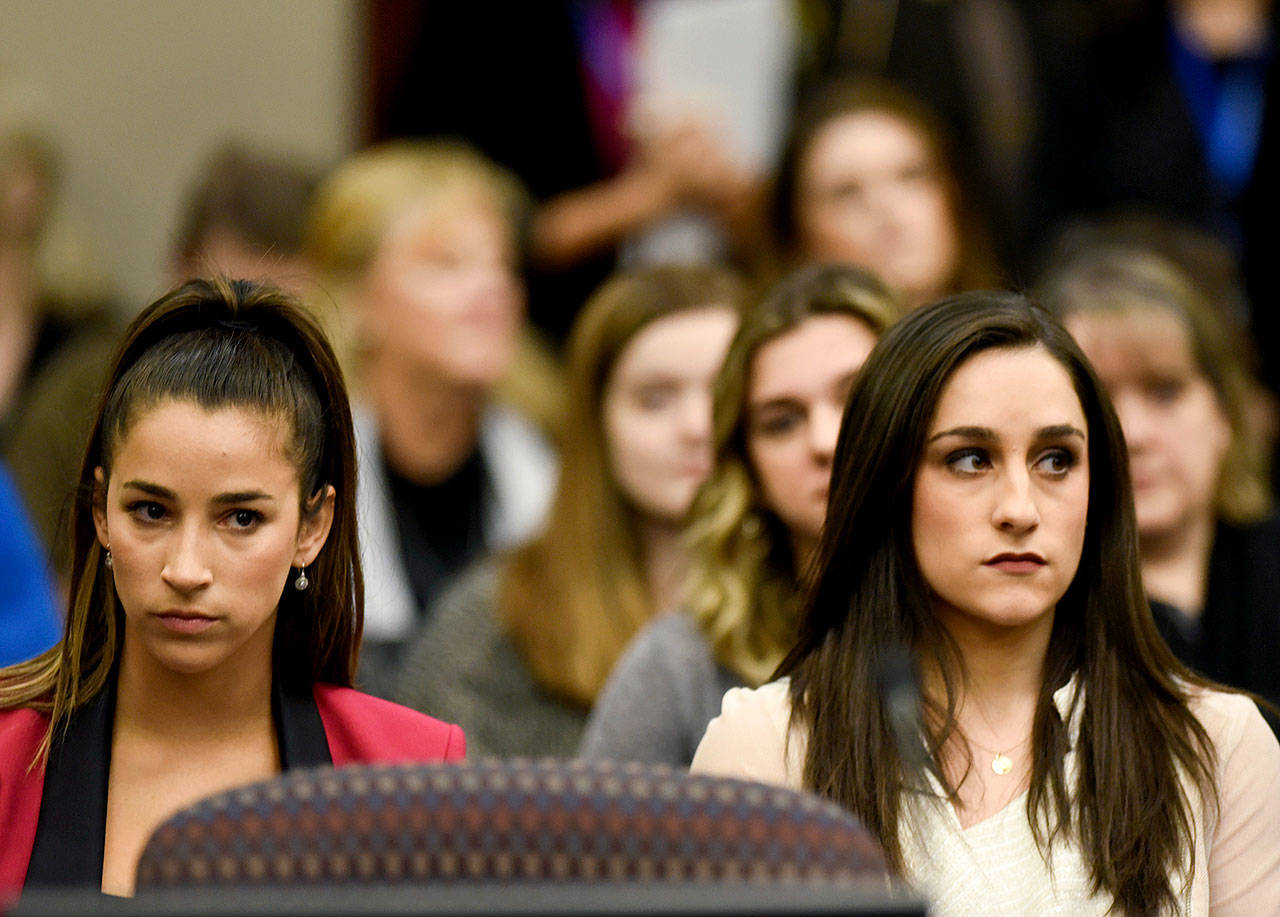 Former Olympians Aly Raisman (left) and Jordyn Wieber sit in Circuit Judge Rosemarie Aquilina’s courtroom during the fourth day of sentencing for former sports doctor Larry Nassar, who pleaded guilty to multiple counts of sexual assault in Lansing, Michigan. (Matthew Dae Smith /Lansing State Journal via AP)