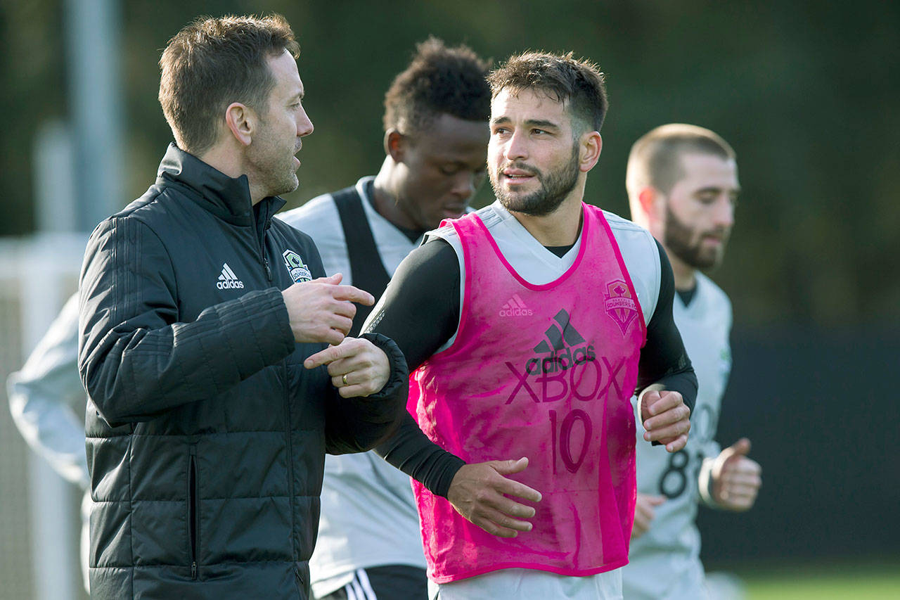 Seattle’s Nicolas Lodeiro (front right) jogs around the field with Damian Roden, the Sounders’ new director of high performance, at the first day of the Sounders’ MLS training camp on Jan. 22 in Tukwila. (Bettina Hansen/The Seattle Times via AP)