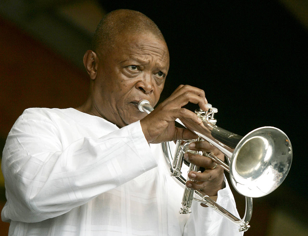 In an April 2006 photo, Hugh Masekela performs during the 2006 New Orleans Jazz and Heritage Festival in New Orleans. (AP Photo/Jeff Christensen, File)