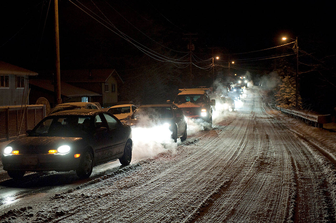 People drive to higher ground early Tuesday in Sitka, Alaska, after tsunami sirens and cell phone messages told residents to leave after a 7.9 magnitude earthquake struck in the Gulf of Alaska. (James Poulson/Daily Sitka Sentinel via AP)