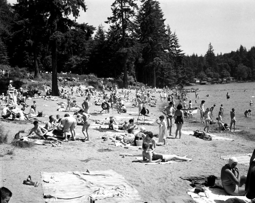 Sunbathers at Lake Goodwin State Park (Wenberg Park) near Stanwood in June 1958. Librarian Rob Branigin hopes to record oral histories, including stories about what it was like growing up around Stanwood in the mid-20th century. (Herald file)
