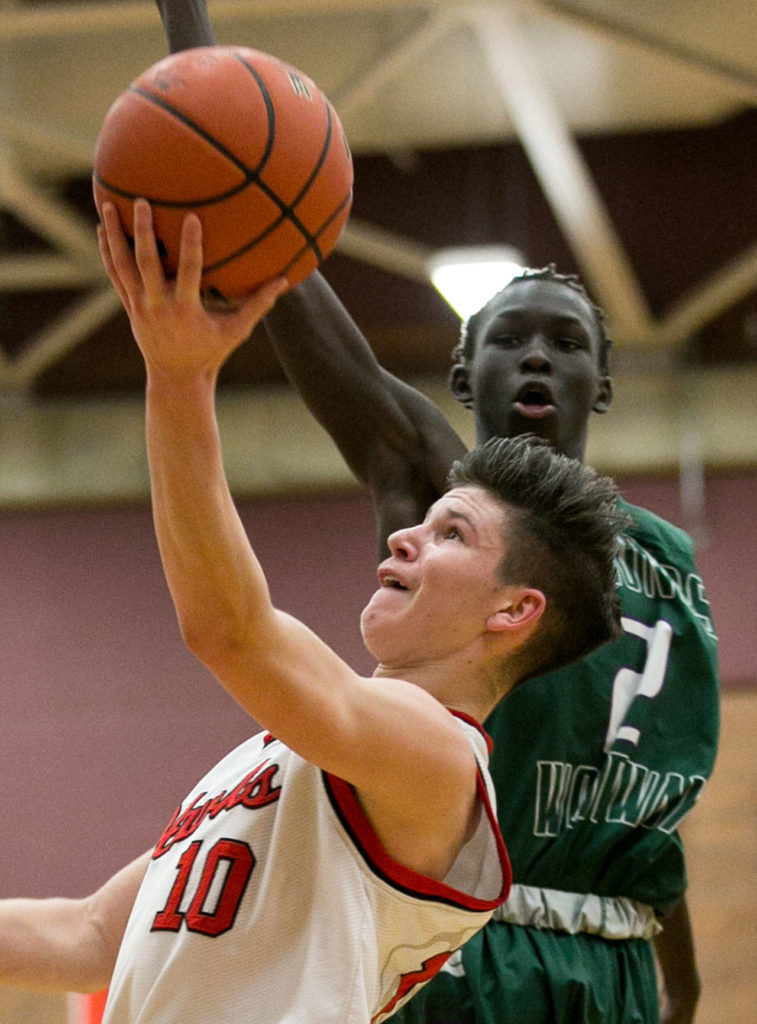 Mountlake Terrace’s Mason Christianson attempts a shot past Edmonds-Woodway’s Mutdung Bol during a game Jan. 23, 2018, at Mountlake Terrace High School. (Kevin Clark / The Herald)
