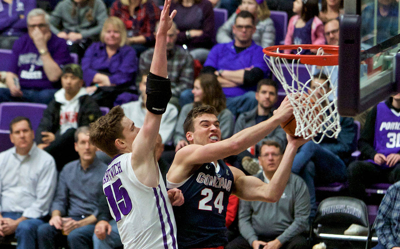 Gonzaga forward and King’s alum Corey Kispert (right) shoots next to Portland center Philipp Hartwich during the first half of a game on Jan. 25, 2018, in Portland, Ore. (AP Photo/Craig Mitchelldyer)