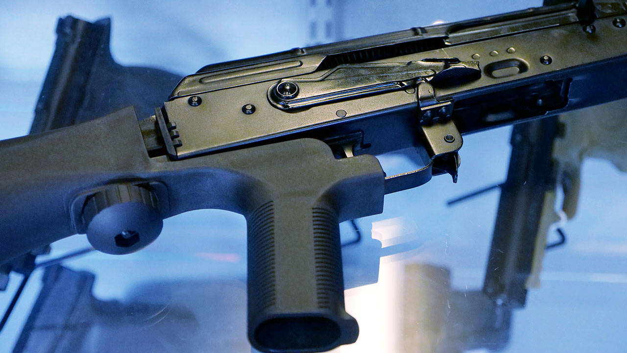 A “bump stock” is attached to a semi-automatic rifle at the Gun Vault store and shooting range in South Jordan, Utah. (Rick Bowmer / Associated Press)