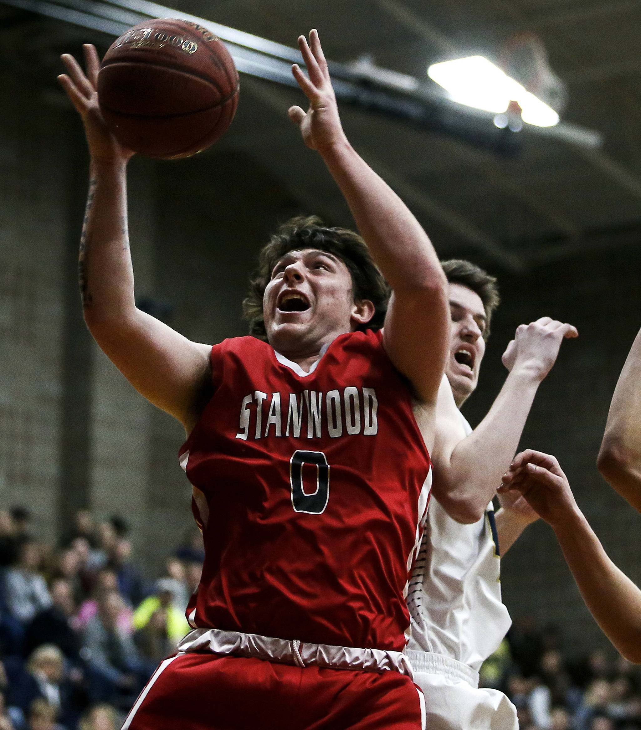 Stanwood’s Mitch Jones (0) grabs a rebound during a game against Arlington on Jan. 26, 2018, at Arlington High School. (Ian Terry / The Herald)