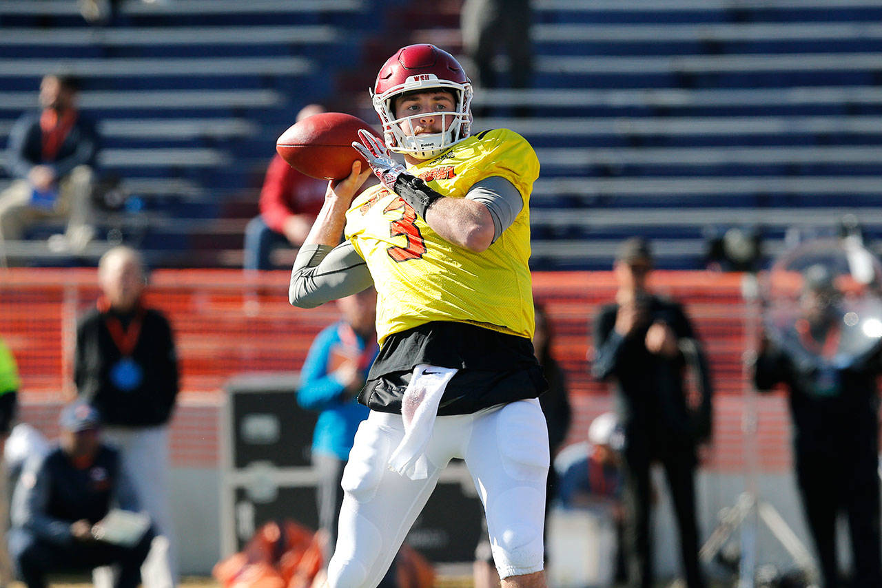 North squad quarterback Luke Falk, of Washington State, prepares to pass during practice for the Senior Bowl on Jan. 25, 2018, in Mobile, Ala. Falk is wearing a No. 3 jersey in honor of former teammate Tyler Hilinski, who committed suicide last week. (AP Photo/Brynn Anderson)