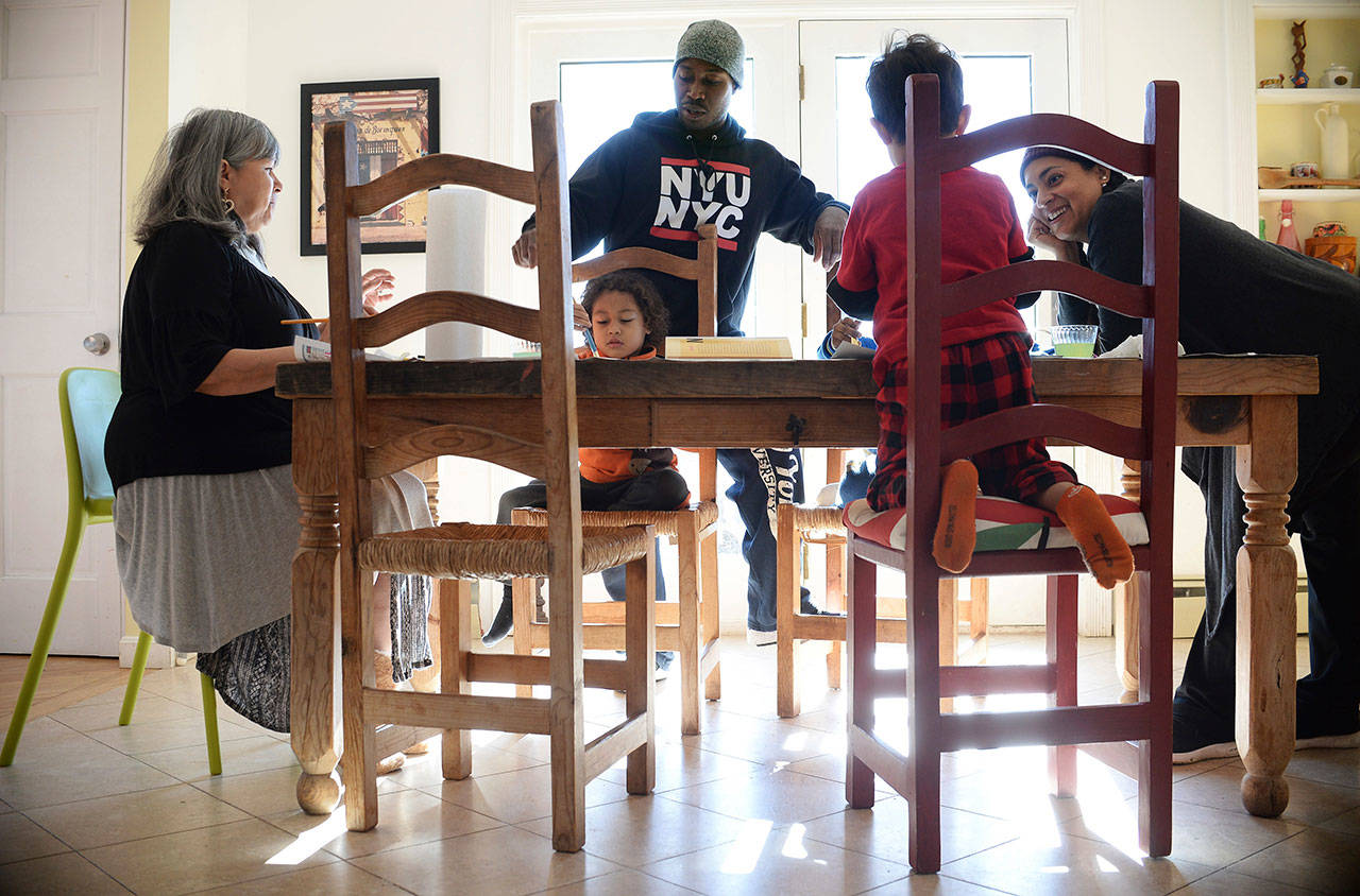 Artist and author Maybeth Morales, left, leads a home school art class for her grandchildren as her daughter Chemay Morales-James, right, and son-in-law Shane, center, watch in Watertown, Conn., on Jan. 26, 2018. Reports that 13 malnourished siblings allegedly held captive by their parents were home-schooled has others who educate their children at home bracing for calls for more oversight of the practice, a reaction they say would unfairly punish families. (AP Photo/Jessica Hill)