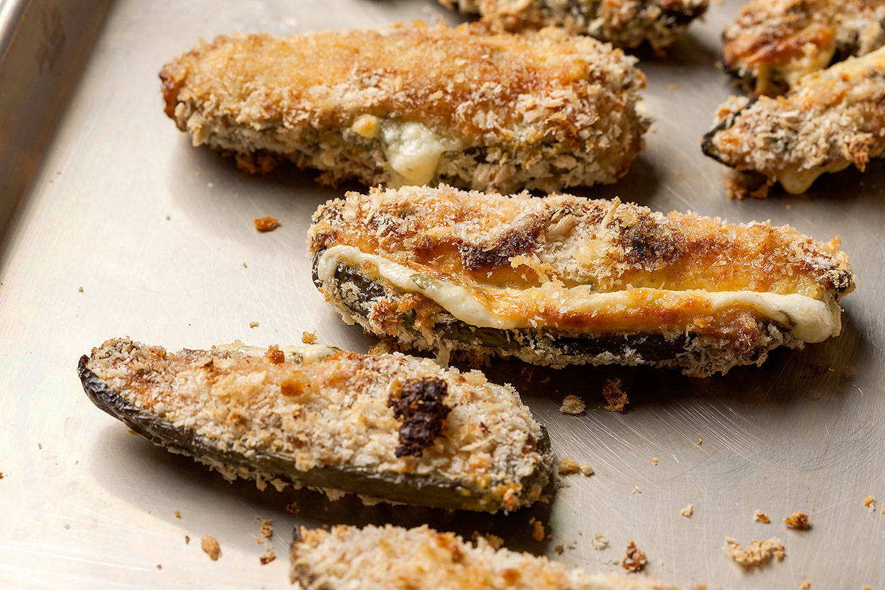 Baked jalapeno poppers deliver the fun and flavor of the bar food staple in a more healthful way. (Goran Kosanovic for The Washington Post)