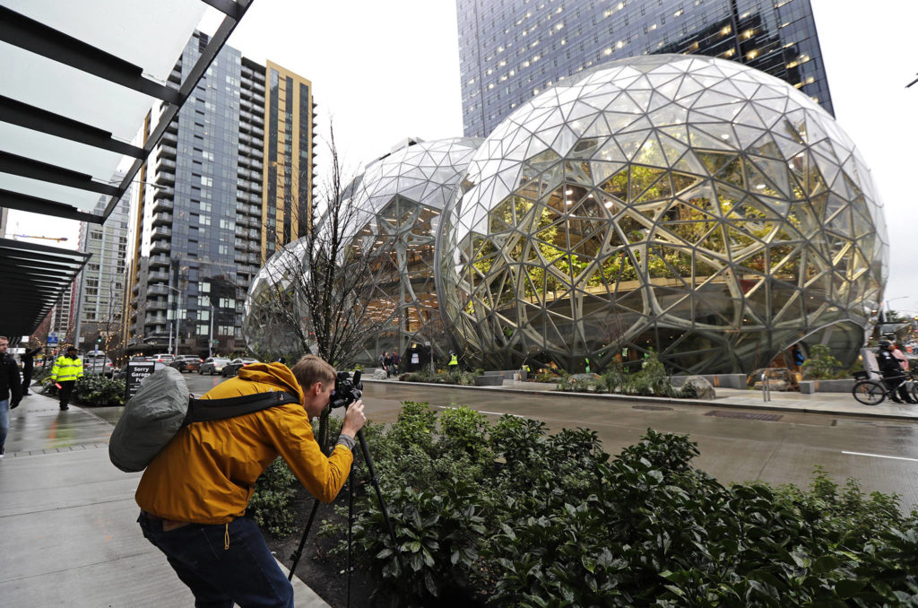 Alex Crook, a photographer with Seattle Magazine, photographs the Amazon Spheres in downtown Seattle on the day of their grand opening in Seattle. (AP Photo/Ted S. Warren)
