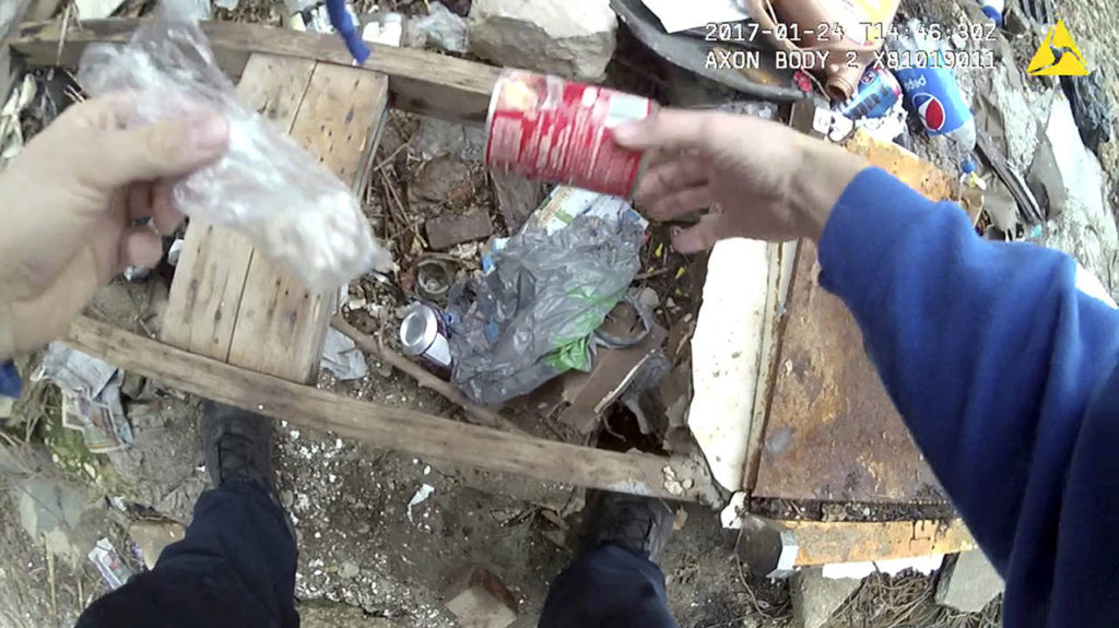 Baltimore Police Officer Richard Pinheiro has been indicted on charges of fabricating evidence and misconduct after his body-cam video showed him placing a soup can at a crime scene, then returning to pick up the can and seemingly discover the drugs inside it. (Baltimore Police Department via AP)
