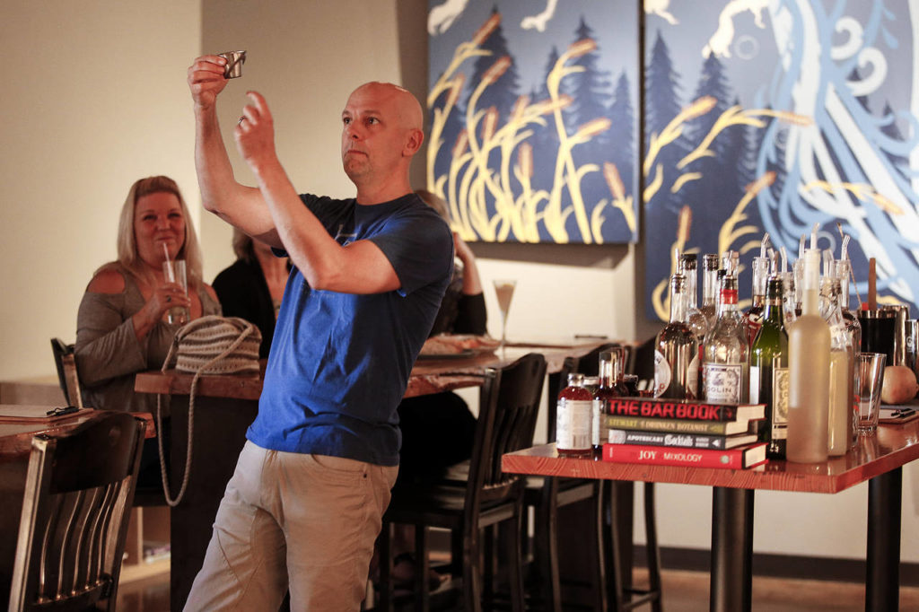 Bluewater Distilling owner, John Lundin gives a lesson on tools used for making cocktails during a monthly class offered at the Everett distillery. (Ian Terry / The Herald)
