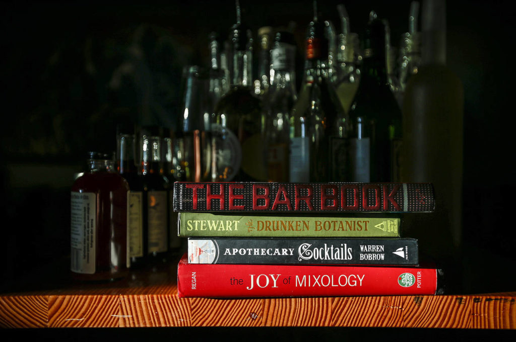 Books on making cocktails are seen at Bluewater Distilling in Everett. (Ian Terry / The Herald)
