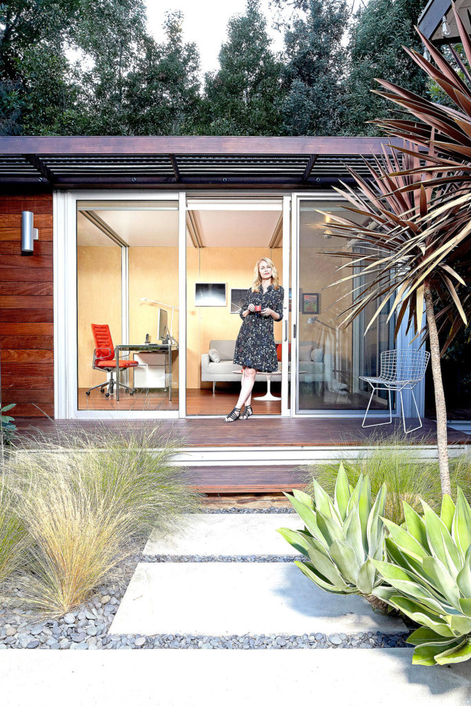 Chelsea Hadley relaxes outside her luxury storage-shed conversion in Beverly Hills, California. She uses it for a retreat and for an office. (Photo by Douglas Hill for The Washington Post)
