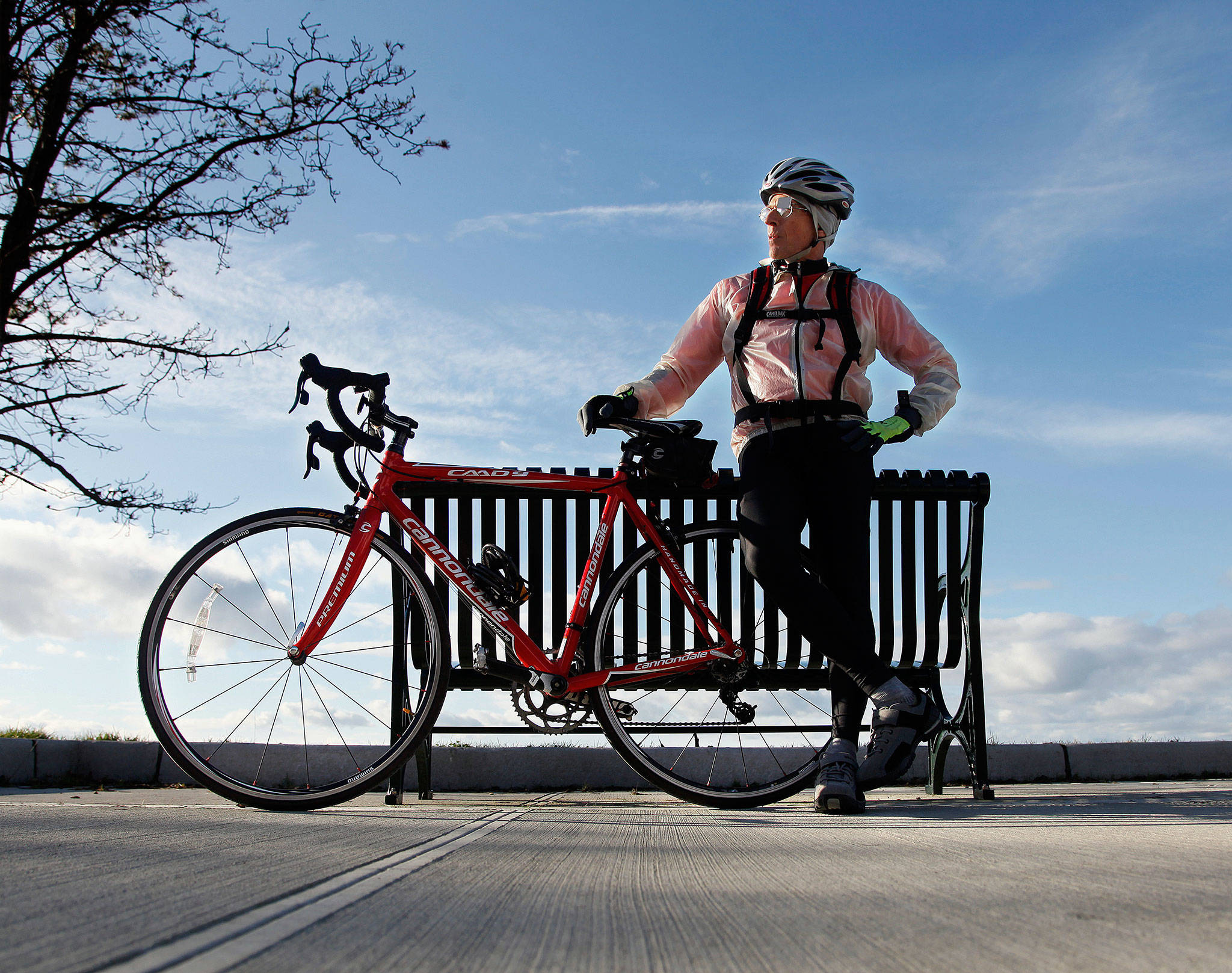 Dr. Art Grossman, a longtime Everett family practice physician, soccer coach and YMCA fitness instructor, died Dec. 21 of ALS. Grossman is seen here in 2013, stopped along Marine View Drive in Everett with his bike. (Dan Bates / Herald file)