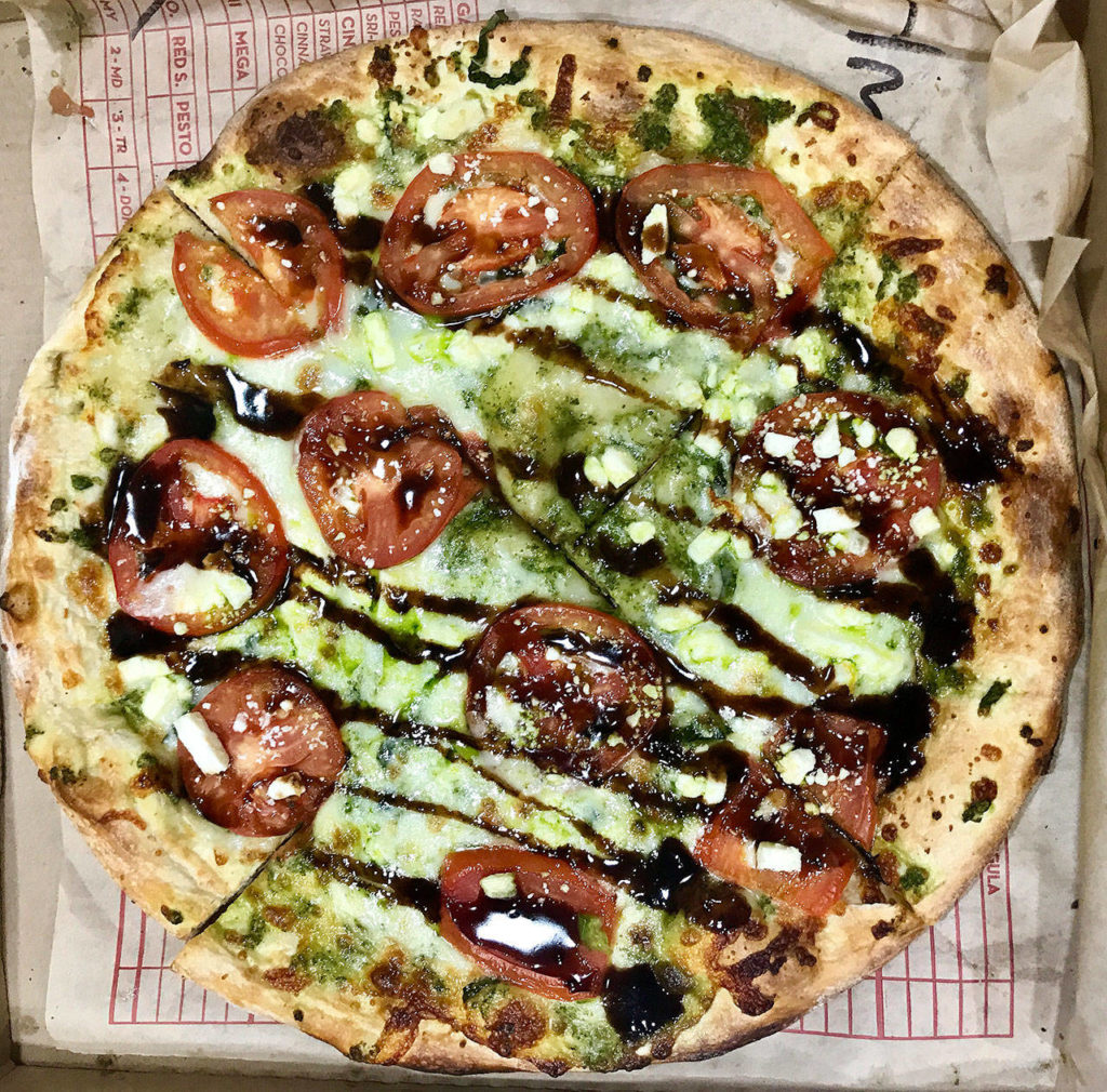An 11-inch pizza with pesto sauce, veggies and dribbled with balsamic vinegar from MOD Pizza is $8.27. (Andrea Brown/The Herald)
