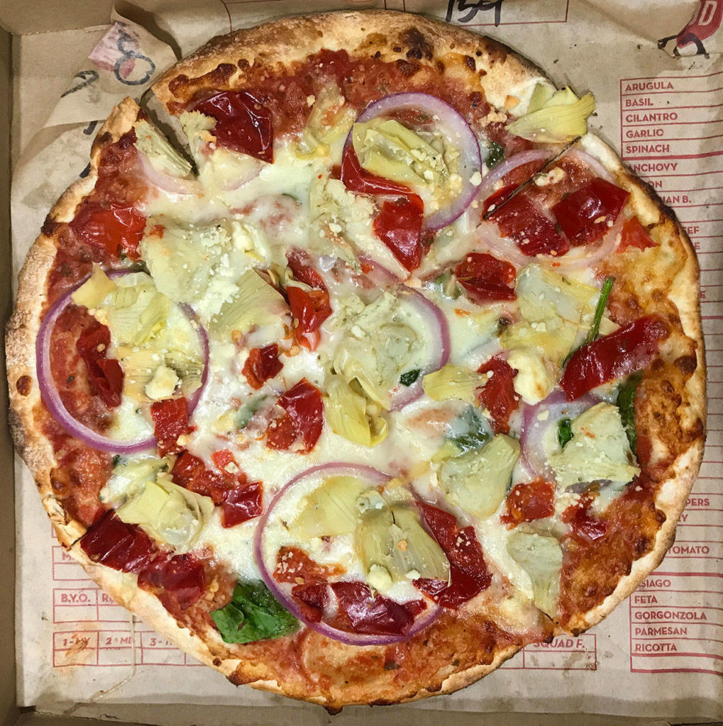 An 11-inch pizzA with red sauce, artichokes, broccoli, cauliflower and peppers from MOD Pizza is $8.27. (Andrea Brown/The Herald)
