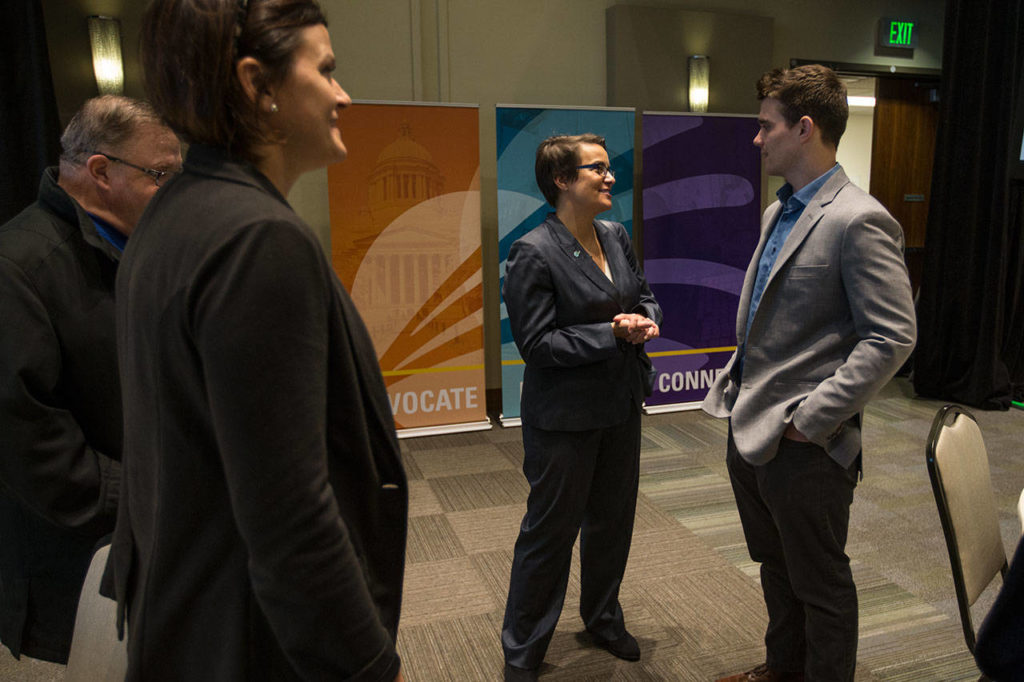 Everett Mayor Cassie Franklin speaks with Austin Hicks after her first of State of Everett address held at the Ed Hansen Conference Center in the Angel of the Winds Arena on Wednesday in Everett. (Andy Bronson / The Herald)
