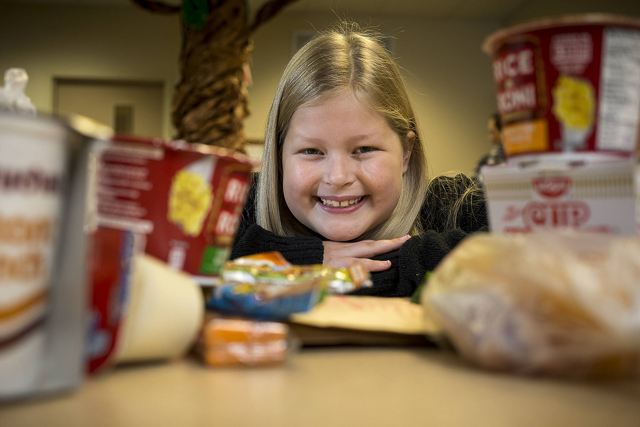Anneliese Ballou donated her birthday money to Hungry Hearts, which provides students meals to take home for weekends and holidays. She has been named the first student ambassador for Hungry Hearts at Highland Elementary. With the foods kids get in bags on Friday on Friday, Jan. 19, 2018 in Lake Stevens, Wa. (Andy Bronson / The Herald)
