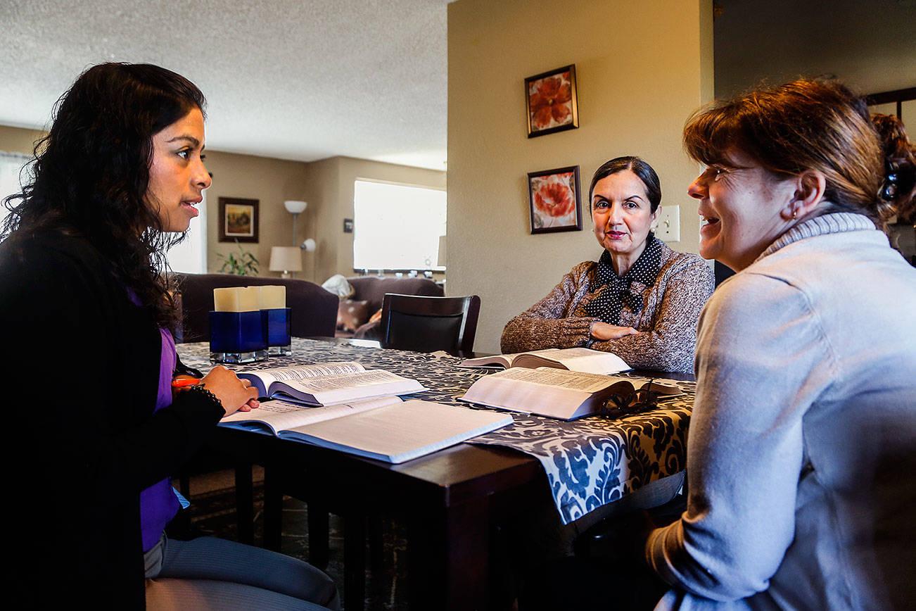 Faith Lutheran Church (of Everett) pastor Arhiana Shek (left) conducts a Bible study in Spanish with members Martha Schutten (center) and Fran Ulloa at Ulloa’s home in Lynnwood on Jan. 16. Although all the women speak and read English, studying in their first language, from a Spanish Bible, is a way to ensure they are understanding the intended meaning. (Dan Bates / The Herald)
