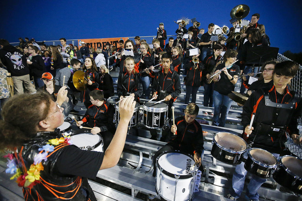 Sage Strecker (left), drum major for Granite Falls High School, leads the band through a quick tune during a timeout in the first quarter of a football game at the school in 2016. (Ian Terry / Herald file)
