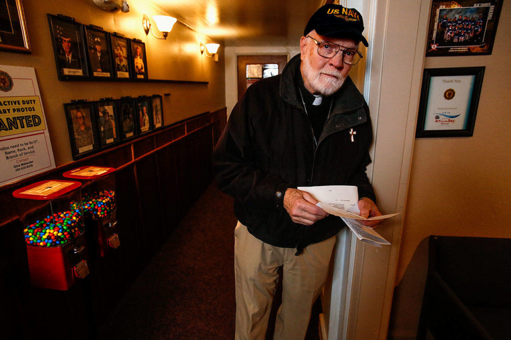 At Stanwood’s American Legion Post 92, Navy veteran and Post Chaplain Phil Lewis, 85, discusses the serious need for replacement of the building’s load-bearing substructure beneath the hallway floor. (Dan Bates / The Herald)
