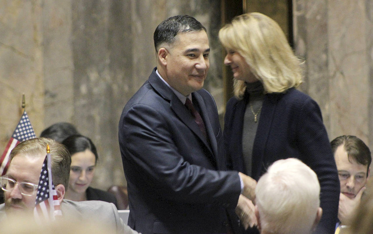 Senator Steve Hobbs, D-Lake Stevens, shakes hands with Senator Patty Kuderer, D-Bellevue, after SB 6219 passed the senate chamber. (Taylor McAvoy / WNPA Olympia News Bureau)