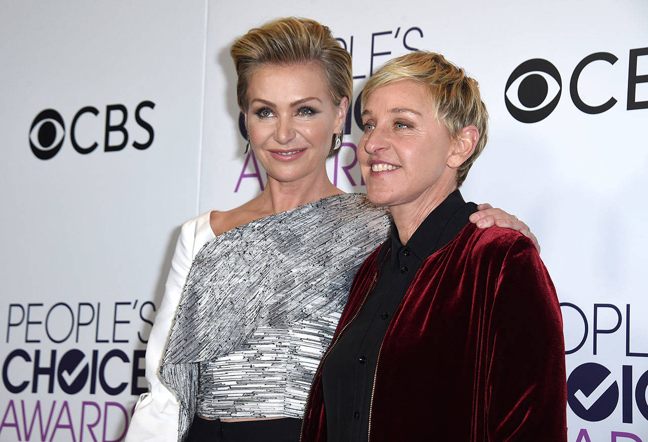 Portia de Rossi (left) and Ellen DeGeneres, winner of the awards for favorite animated movie voice, favorite daytime TV host, and favorite comedic collaboration, pose in the press room at the People’s Choice Awards in Los Angeles in January. (Photo by Jordan Strauss / Invision file)