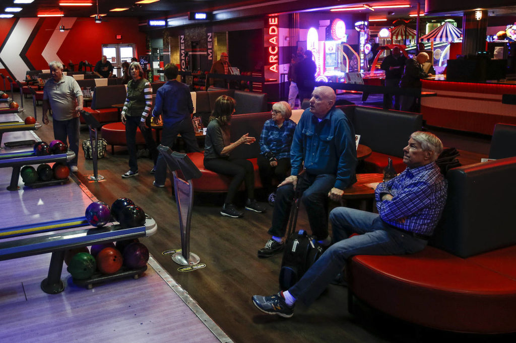 People wait their turn at the newly opened Bowlero bowling alley in Lynnwood. (Ian Terry / The Herald)
