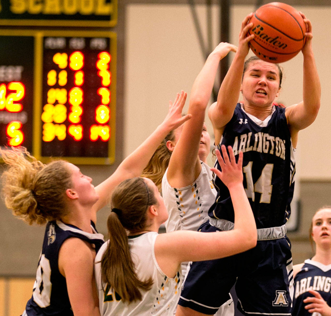 Arlington’s Peyton Brown pulls down a rebound Friday at Shorecrest High School. (Kevin Clark / The Daily Herald)