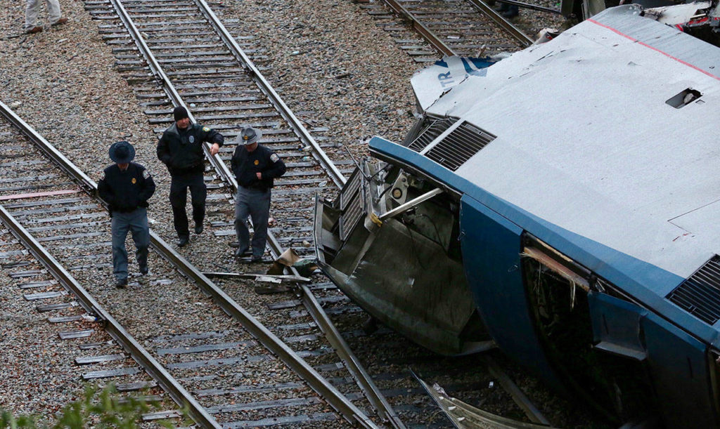 Authorities investigate the scene of a fatal Amtrak train crash in Cayce, South Carolina, Sunday, Feb. 4, 2018. At least two were killed and dozens injured. (Tim Dominick/The State via AP)
