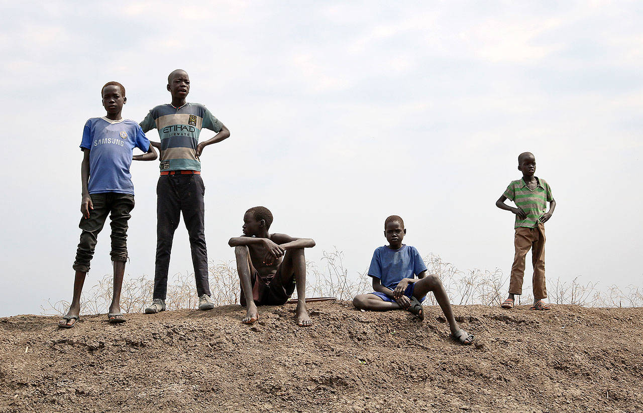 In this photo taken Jan. 20, children stand on the banks of the Nile overlooking the Ethiopian border in Akobo town, one of the last rebel-held strongholds in South Sudan. (AP Photo/Sam Mednick)