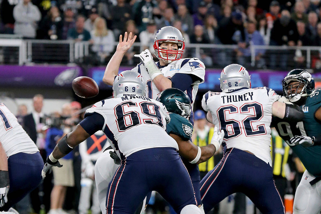 New England Patriots quarterback Tom Brady fumbles after being hit by Brandon Graham of the Philadelphia Eagles in the fourth quarter of Sunday’s Super Bowl. (AP Photo/Gregory Payan)