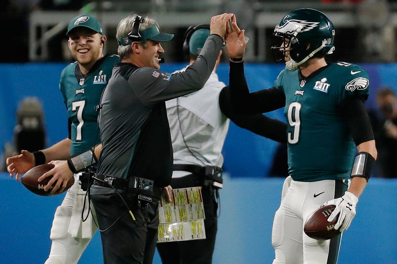 Philadelphia Eagles quarterback Nick Foles (9) celebrates a touchdown with head coach Doug Pederson during the first half Sunday’s Super Bowl. (AP Photo/Charlie Neibergall)