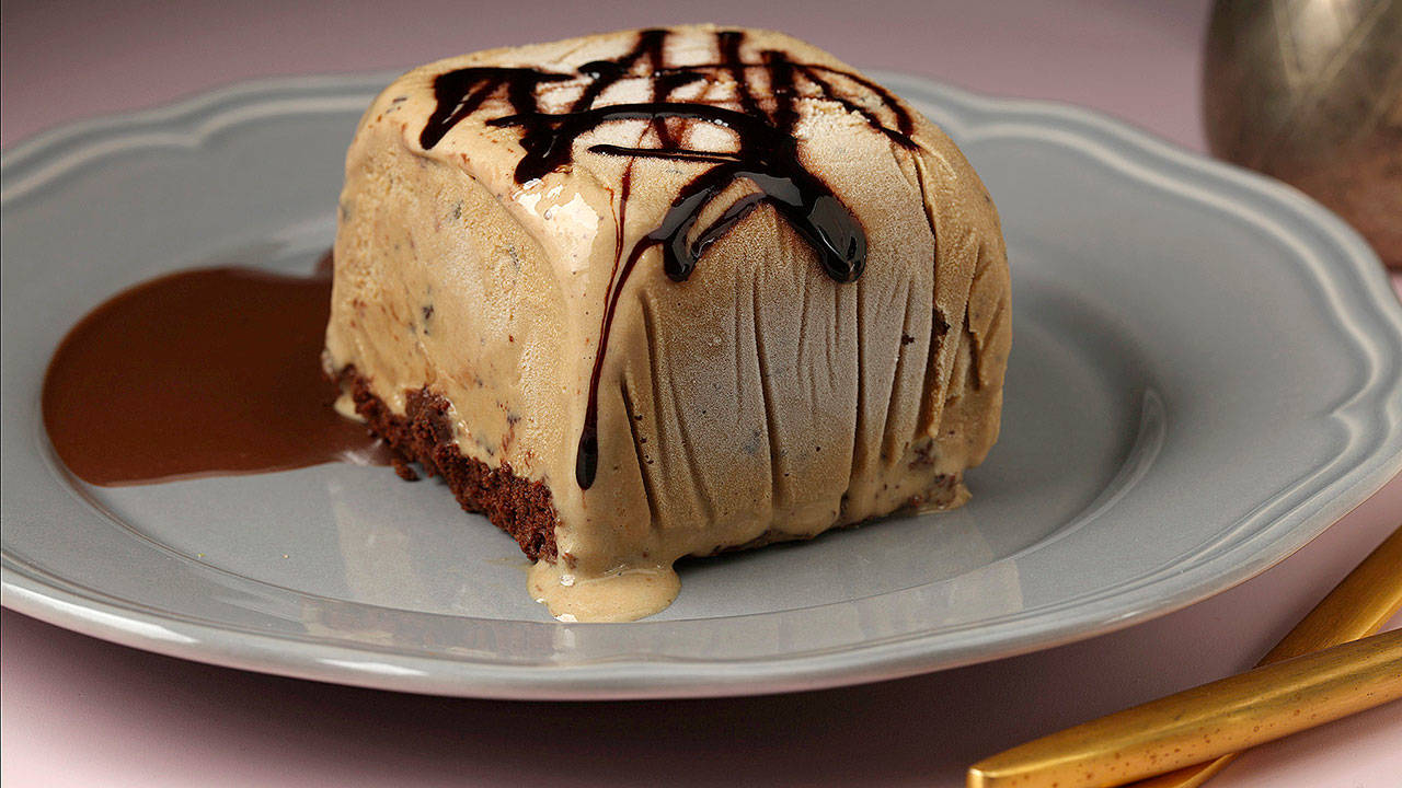 The cake-and-ice-cream squares are built on a base of chocolate cake, flavored with coffee, and are topped with coffee chip ice cream. Your favorite chocolate sauce finishes the treat. (E. Jason Wambsgans/Chicago Tribune)