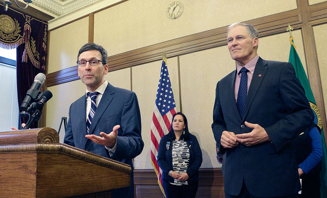 Washington Attorney General Bob Ferguson (left) speaks to the media on Monday in Olympia about the state’s opposition to the Trump administration proposal to expand offshore drilling. At right is Gov. Jay Inslee. (AP Photo/Rachel La Corte)