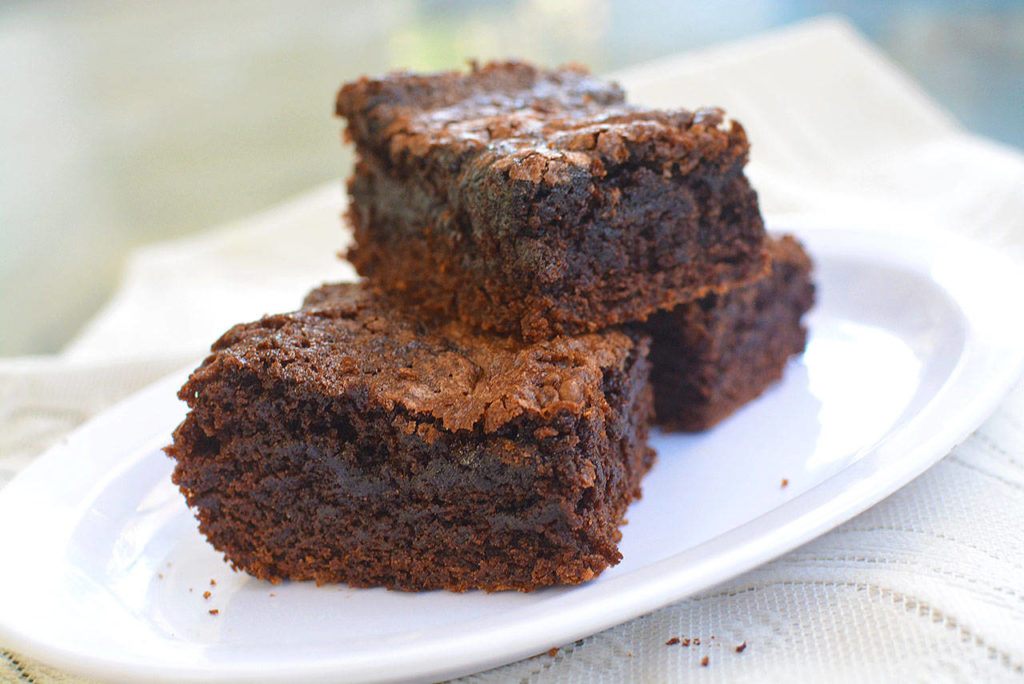 The recipe for dark chocolate brownies adds in melted milk chocolate and crumbled walnuts.
