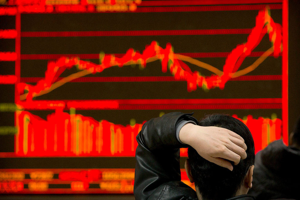 An investor monitors stock prices at a brokerage house in Beijing on Tuesday. (AP Photo/Mark Schiefelbein)
